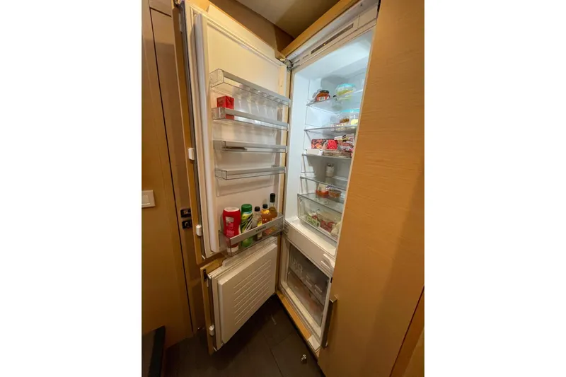 Chicago Yacht Photos Pics Open refrigerator inside 2020 Lagoon 52 F yacht, stocked with various food items.