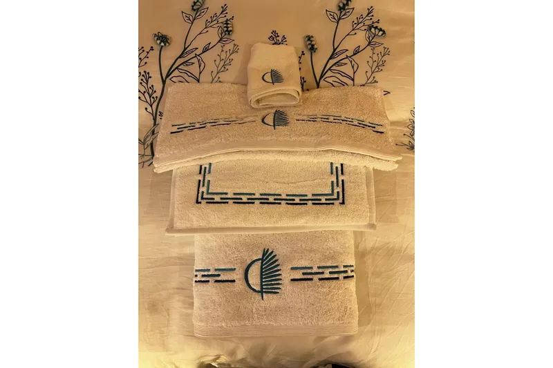 Chicago Yacht Photos Pics Elegant embroidered towels on floral-patterned bedding, showcasing luxury and style.