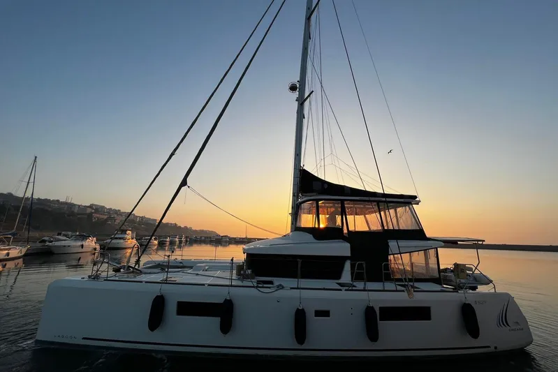 Chicago Yacht Photos Pics Lagoon 52 F catamaran at sunset, 2020 model, docked in a serene harbor.