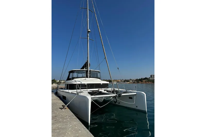 Chicago Yacht Photos Pics 2020 Lagoon 52 F catamaran docked in a serene harbor under clear blue skies.