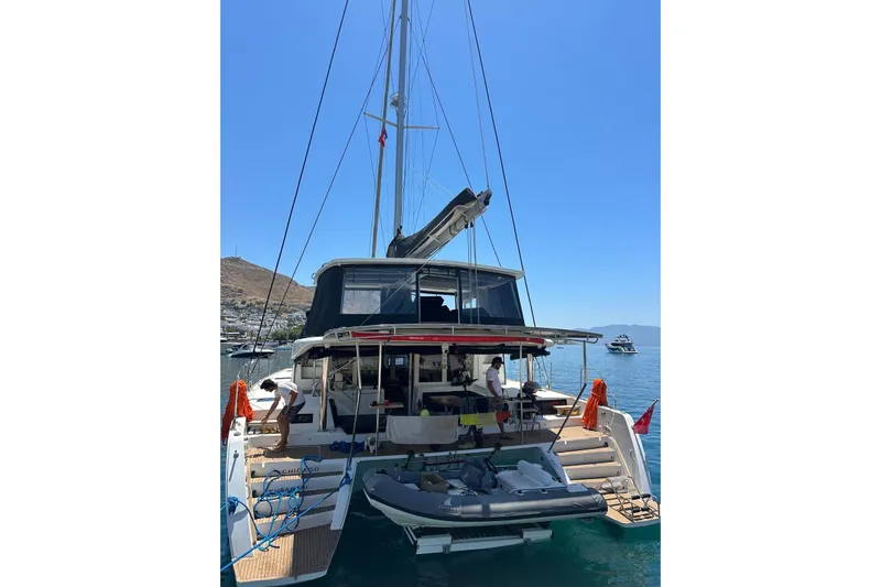 Chicago Yacht Photos Pics 2020 Lagoon 52 F catamaran docked, featuring spacious deck and clear blue sky.