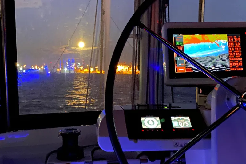 Chicago Yacht Photos Pics Cockpit view from 2020 Lagoon 52 F yacht, night navigation with moonlit harbor.