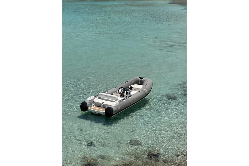 Chicago Yacht Photos Pics Inflatable boat floating on clear turquoise water, near a Lagoon 52 F, 2020 model.