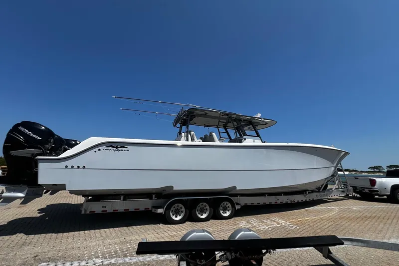 Reel Deployment Yacht Photos Pics 2022 Invincible 46 Catamaran on trailer, parked under clear blue sky.
