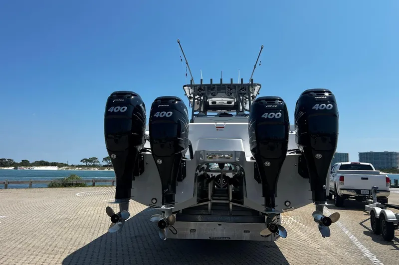 Reel Deployment Yacht Photos Pics 2022 Invincible 46 Catamaran with four powerful outboard engines, docked by the waterfront.