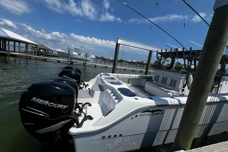 Reel Deployment Yacht Photos Pics 2022 Invincible 46 Catamaran with Mercury engines docked under a clear blue sky.