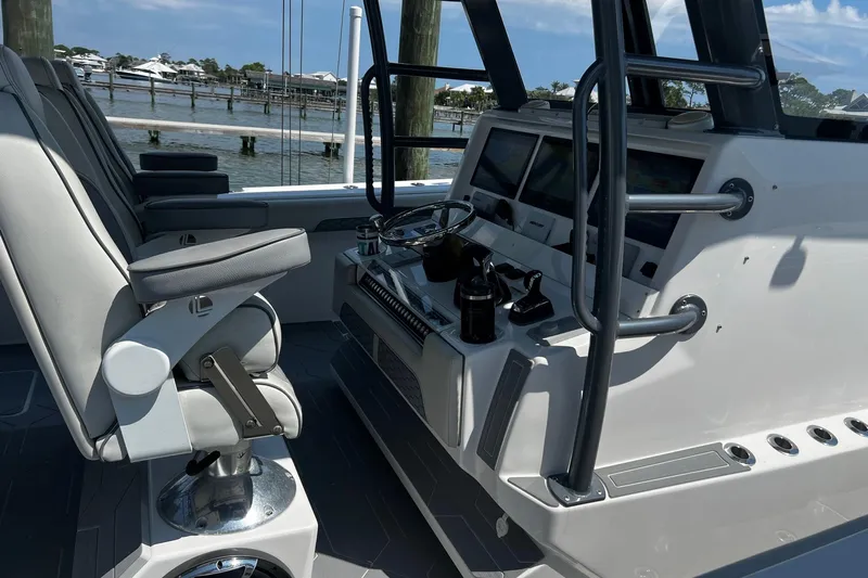 Reel Deployment Yacht Photos Pics 2022 Invincible 46 Catamaran helm with modern controls and seating, dockside view.