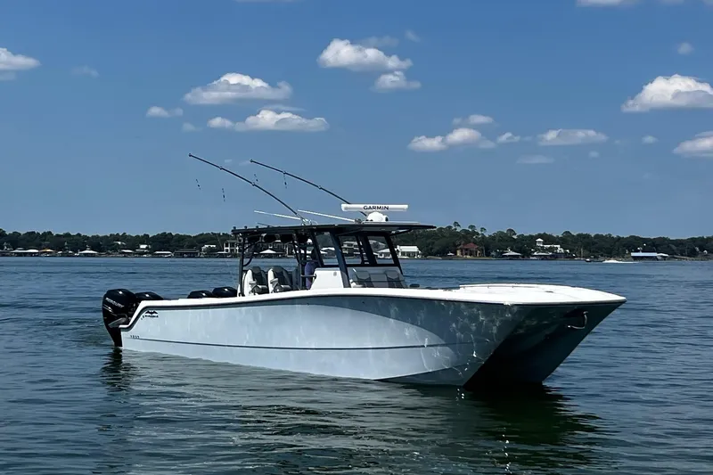 Reel Deployment Yacht Photos Pics 2022 Invincible 46 Catamaran on calm water under a clear blue sky.