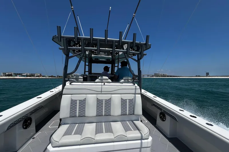 Reel Deployment Yacht Photos Pics 2022 Invincible 46 Catamaran cruising on open water under clear blue skies.