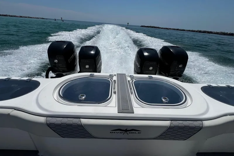 Reel Deployment Yacht Photos Pics 2022 Invincible 46 Catamaran with four powerful outboard engines cruising on open water.