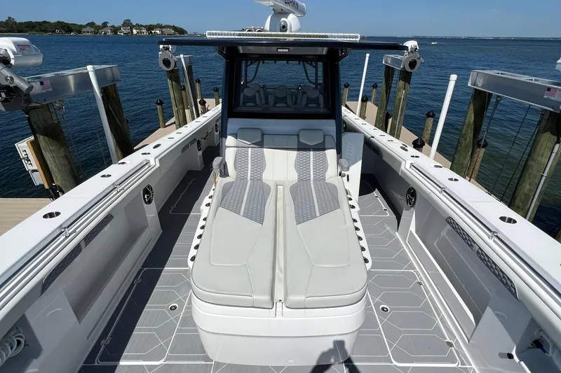 Reel Deployment Yacht Photos Pics 2022 Invincible 46 Catamaran with sleek seating, docked by the ocean.