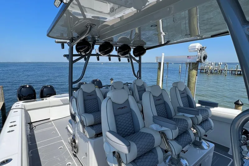 Reel Deployment Yacht Photos Pics Luxurious 2022 Invincible 46 Catamaran with plush seating, docked by the serene waterfront.