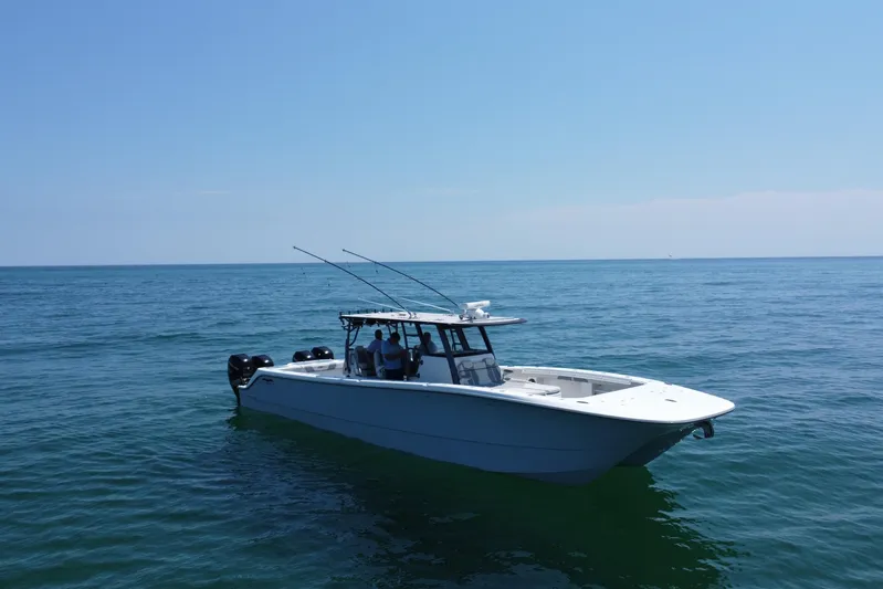 Reel Deployment Yacht Photos Pics 2022 Invincible 46 Catamaran on calm ocean waters under clear blue sky.