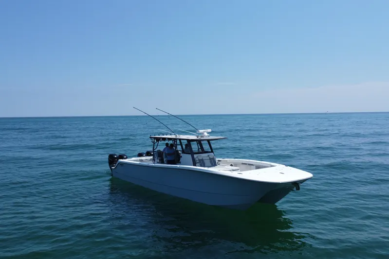 Reel Deployment Yacht Photos Pics 2022 Invincible 46 Catamaran on calm ocean waters under clear blue sky.