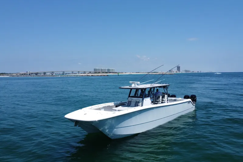 Reel Deployment Yacht Photos Pics 2022 Invincible 46 Catamaran cruising on open water with city skyline in background.