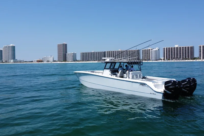 Reel Deployment Yacht Photos Pics 2022 Invincible 46 Catamaran cruising near coastal city skyline.