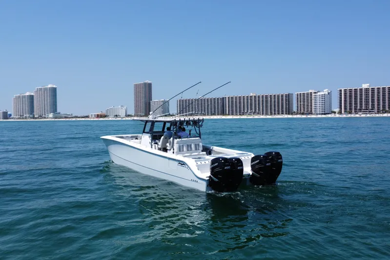 Reel Deployment Yacht Photos Pics 2022 Invincible 46 Catamaran cruising near coastal city skyline.