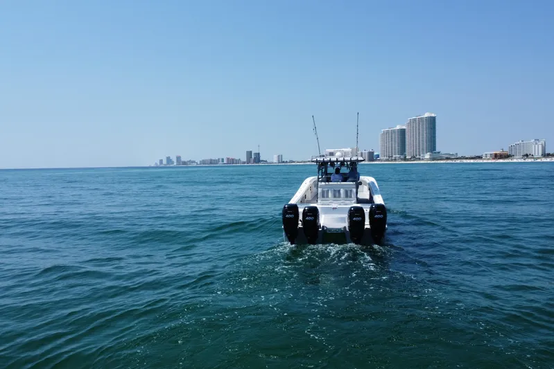 Reel Deployment Yacht Photos Pics Invincible 46 Catamaran 2022 cruising near city skyline on open water.