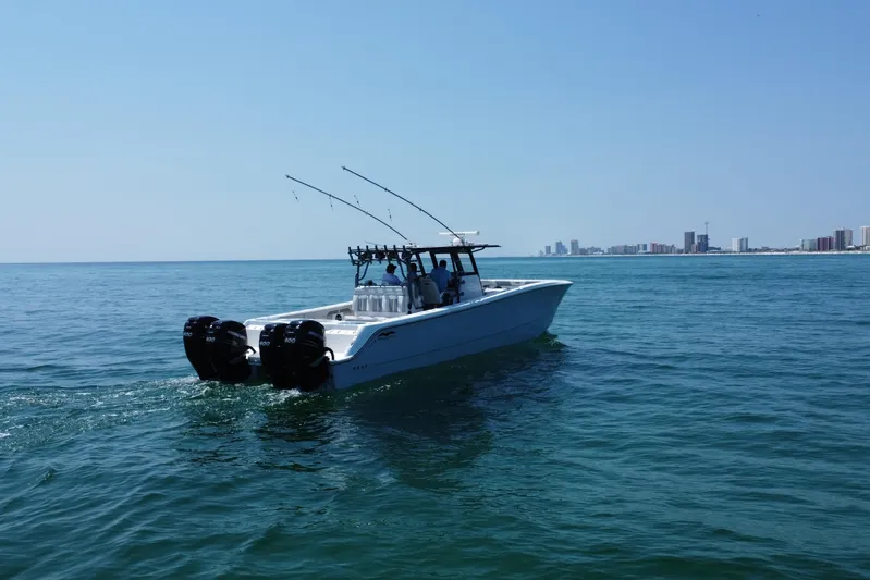 Reel Deployment Yacht Photos Pics 2022 Invincible 46 Catamaran cruising on open water near city skyline.