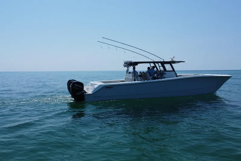 Reel Deployment Yacht Photos Pics 2022 Invincible 46 Catamaran cruising on open water under clear blue sky.