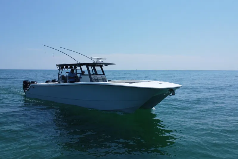 Reel Deployment Yacht Photos Pics 2022 Invincible 46 Catamaran cruising on open water under clear blue skies.