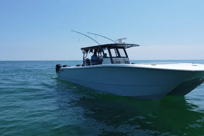 Reel Deployment Yacht Photos Pics 2022 Invincible 46 Catamaran cruising on open water under clear blue sky.
