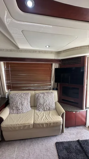 Get N Free Yacht Photos Pics Interior of 2006 Sea Ray 44 Sedan Bridge with beige sofa and wooden blinds.