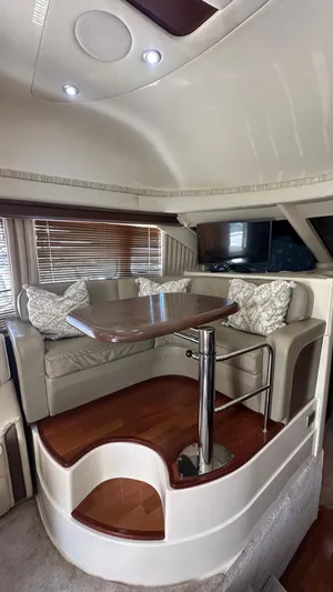 Get N Free Yacht Photos Pics Luxurious interior of 2006 Sea Ray 44 Sedan Bridge with elegant seating and wooden table.