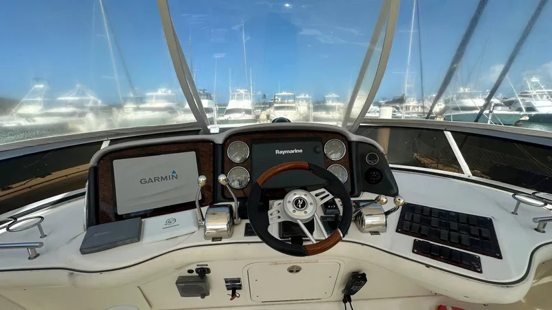 Get N Free Yacht Photos Pics Helm of 2006 Sea Ray 44 Sedan Bridge with Garmin and Raymarine navigation systems.