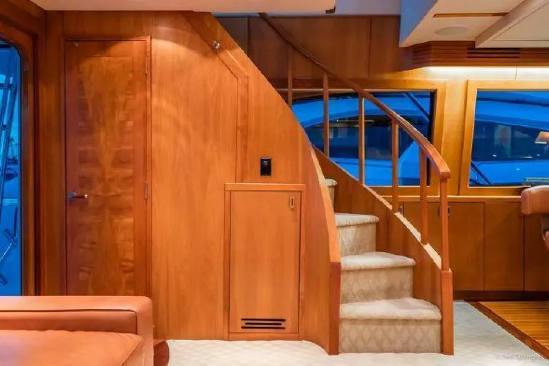 Desperado Yacht Photos Pics Interior of 2008 Hatteras 77 Enclosed Bridge yacht with wooden staircase and luxurious finish.