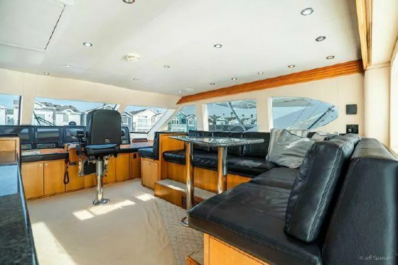 Desperado Yacht Photos Pics Luxurious interior of 2008 Hatteras 77 Enclosed Bridge yacht with leather seating and panoramic windows.