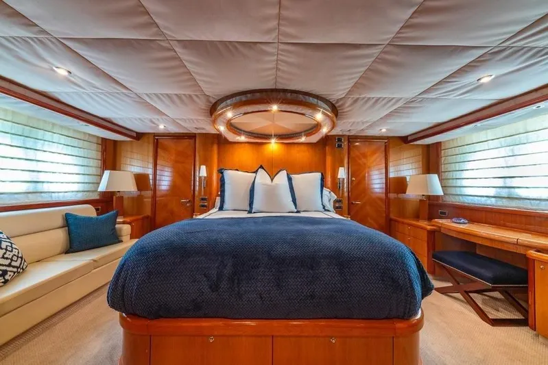 Alaina Yacht Photos Pics Luxurious bedroom interior of 2003 Sunseeker 82 Yacht with elegant wood finishes.