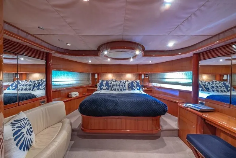 Alaina Yacht Photos Pics Luxurious bedroom interior of 2003 Sunseeker 82 Yacht with elegant wood finishes.