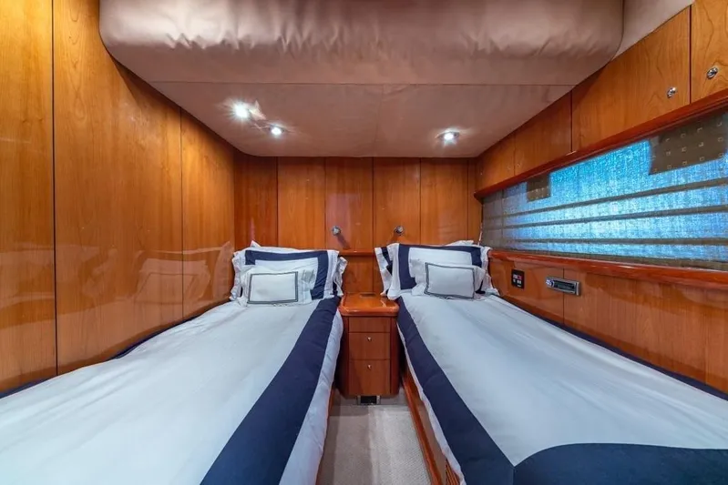 Alaina Yacht Photos Pics Luxurious twin cabin interior on 2003 Sunseeker 82 Yacht with wood paneling and modern lighting.