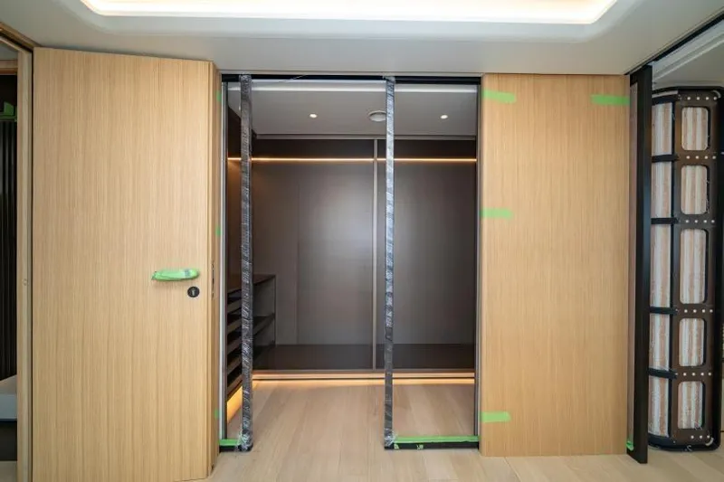 Presence Yacht Photos Pics Modern interior of Cantiere Delle Marche 130.37 yacht, featuring sleek wooden sliding doors, 2026 model.