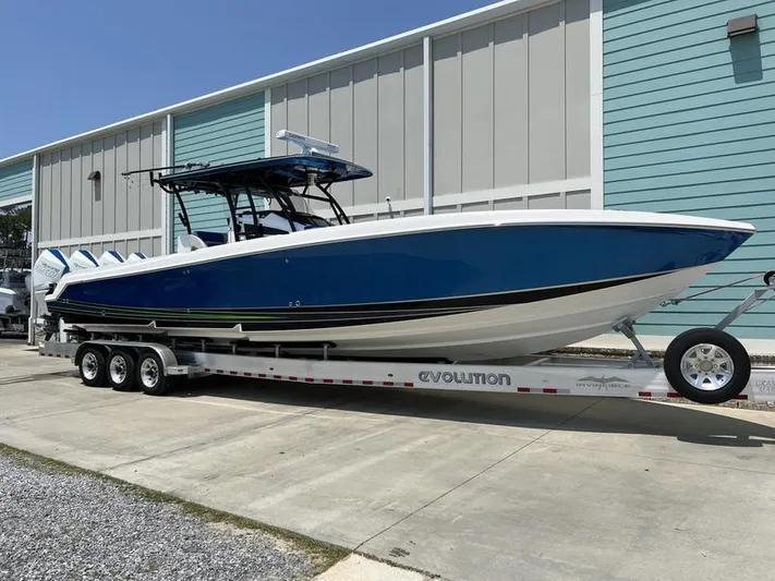  Yacht Photos Pics 2020 Nor-Tech 392 Super Fish boat on a trailer outside a teal building.