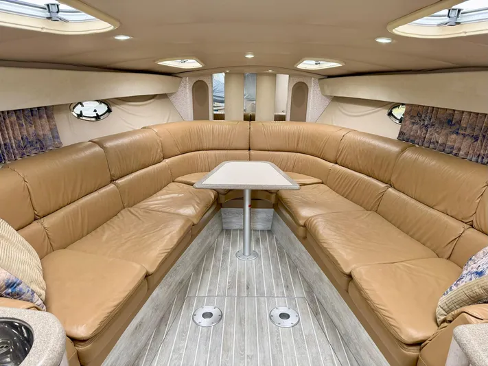 Tony Montana Yacht Photos Pics 1999 Formula 400 Super Sport yacht interior with tan leather seating and wooden flooring.