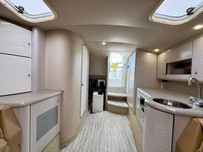 Tony Montana Yacht Photos Pics 1999 Formula 400 Super Sport yacht interior with modern kitchen and seating area.