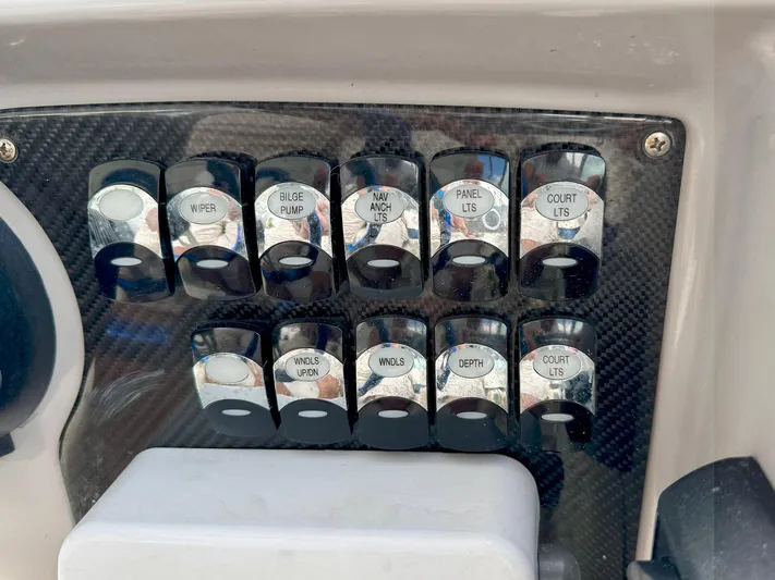 Tony Montana Yacht Photos Pics Control panel switches on a 1999 Formula 400 Super Sport boat dashboard.