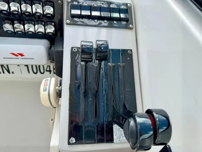 Tony Montana Yacht Photos Pics Control panel of a 1999 Formula 400 Super Sport boat with throttle levers and switches.