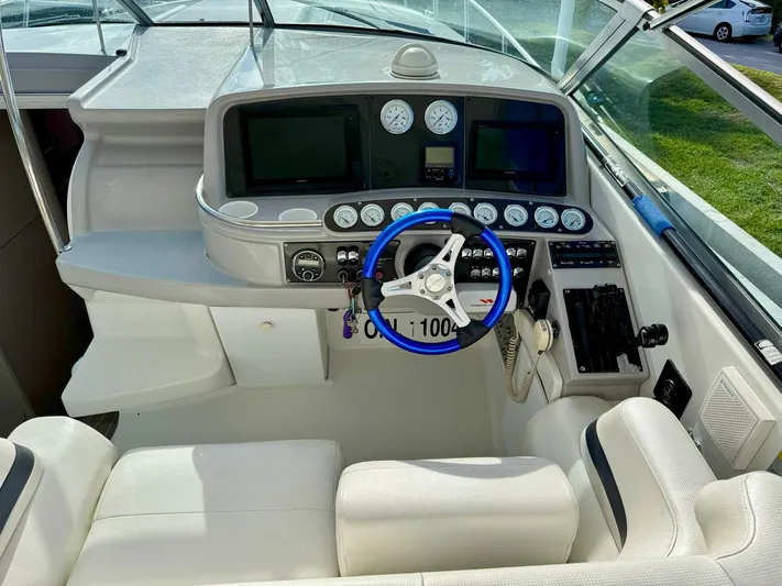 Tony Montana Yacht Photos Pics 1999 Formula 400 Super Sport boat cockpit with steering wheel and control panel.