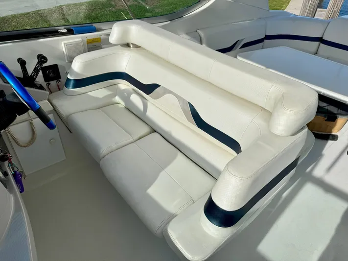 Tony Montana Yacht Photos Pics 1999 Formula 400 Super Sport boat interior with white seating and blue accents.