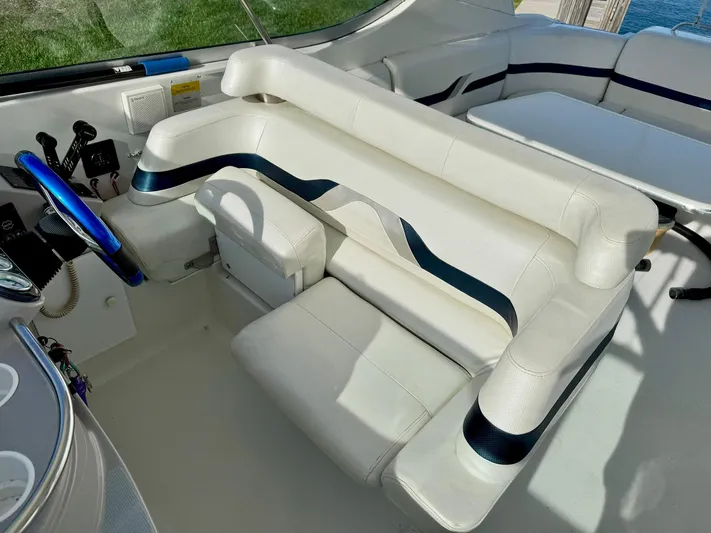 Tony Montana Yacht Photos Pics Interior of a 1999 Formula 400 Super Sport boat with white seating and blue accents.