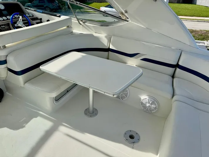 Tony Montana Yacht Photos Pics 1999 Formula 400 Super Sport boat interior with white seating and table.