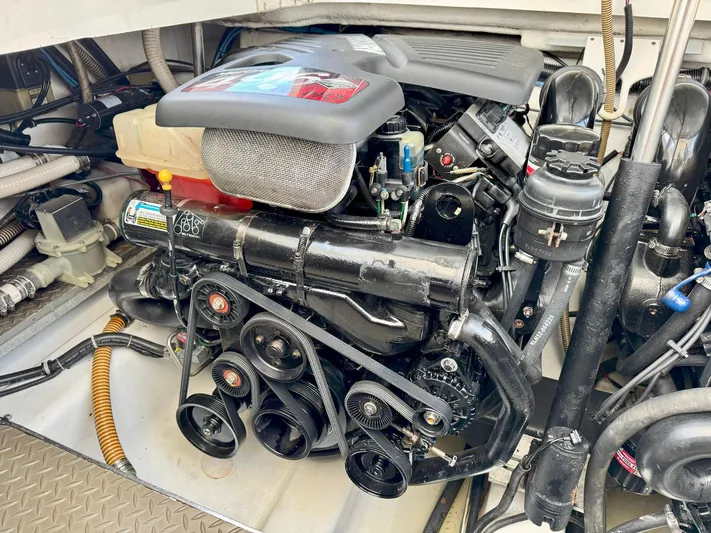 Tony Montana Yacht Photos Pics Engine compartment of a 1999 Formula 400 Super Sport boat, showcasing detailed mechanical components.