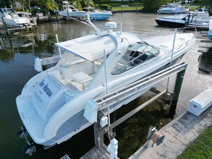 Tony Montana Yacht Photos Pics 1999 Formula 400 Super Sport boat docked at marina, aerial view.