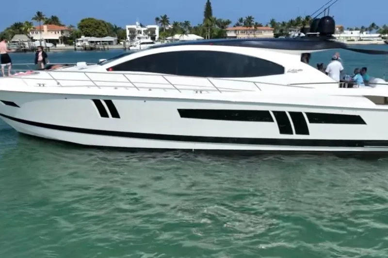 The Office Yacht Photos Pics Luxury 2009 Lazzara LSX 75 yacht cruising in clear waters, with people on deck.