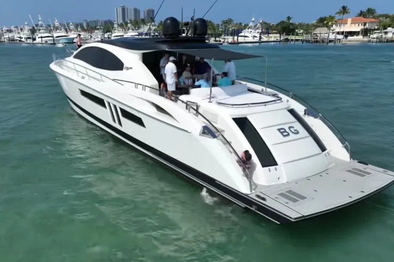 The Office Yacht Photos Pics 2009 Lazzara LSX 75 yacht cruising in clear blue waters, with people on deck.