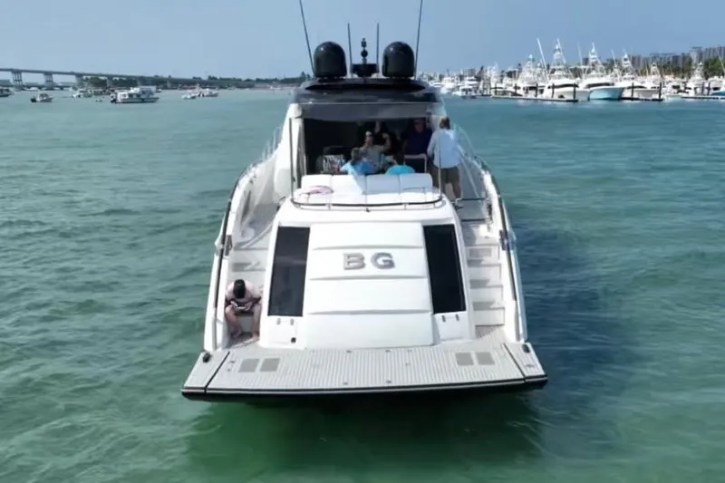 The Office Yacht Photos Pics 2009 Lazzara LSX 75 yacht on water, rear view with people onboard.