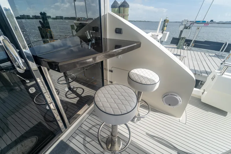 The Office Yacht Photos Pics Luxury yacht Lazzara LSX 75 (2009) with elegant bar stools and waterfront view.